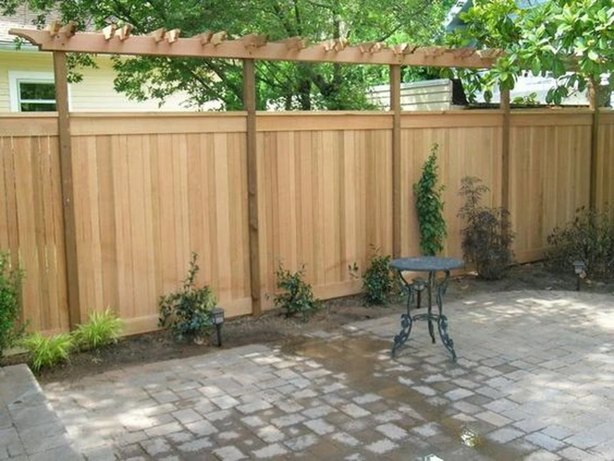 Fence painting tall wooden garden fence in Haywards Heath by Haywards Heath Decorators